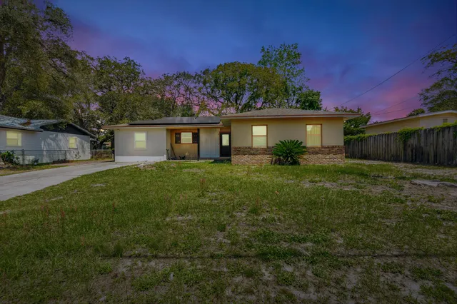 a front view of house with yard and green space
