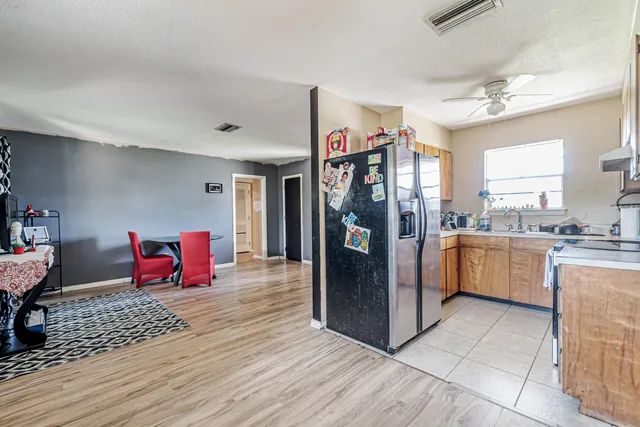 a kitchen view with refrigerator and cabinets