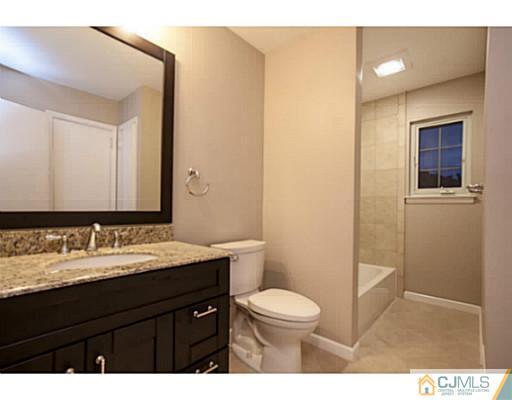 1991 Oak Tree Road Edison, NJ 08820 - Photo 11 of 20 a bathroom with a sink a toilet and mirror