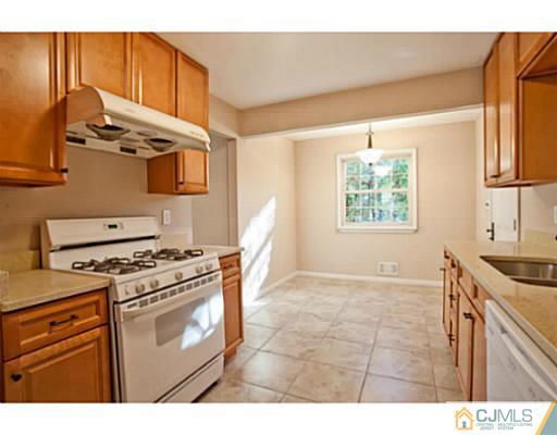 1991 Oak Tree Road Edison, NJ 08820 - Photo 5 of 20 a kitchen with a stove and a microwave