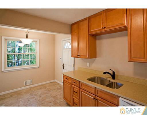 1991 Oak Tree Road Edison, NJ 08820 - Photo 6 of 20 a kitchen with stainless steel appliances granite countertop a sink and cabinets