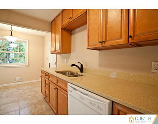 1991 Oak Tree Road Edison, NJ 08820 - Photo 7 of 20 a kitchen with a sink cabinets and window
