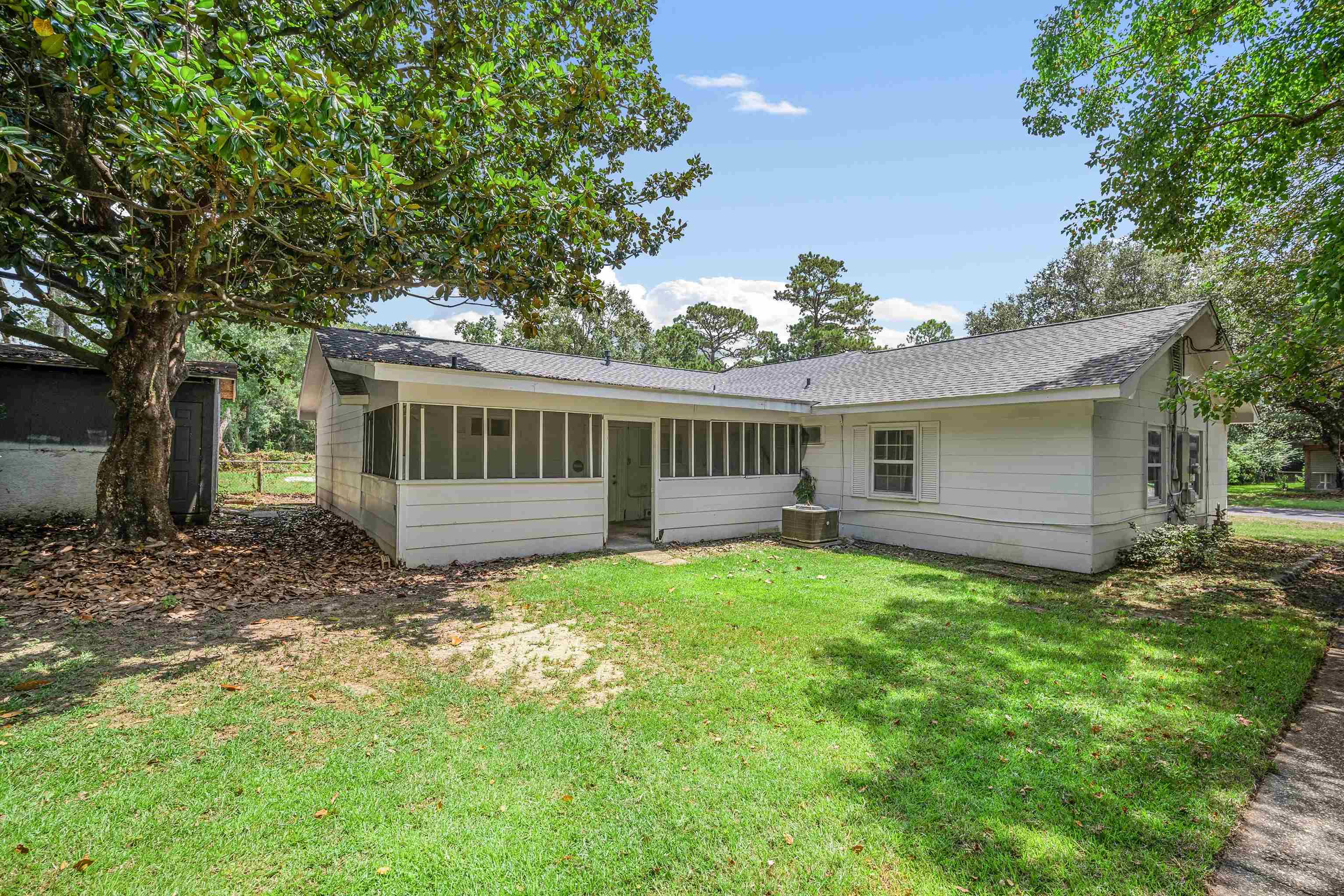 3014 Farcott Street Mobile, AL 36606 - Photo 25 of 26 Back of property featuring a sunroom, a yard, and roof with shingles