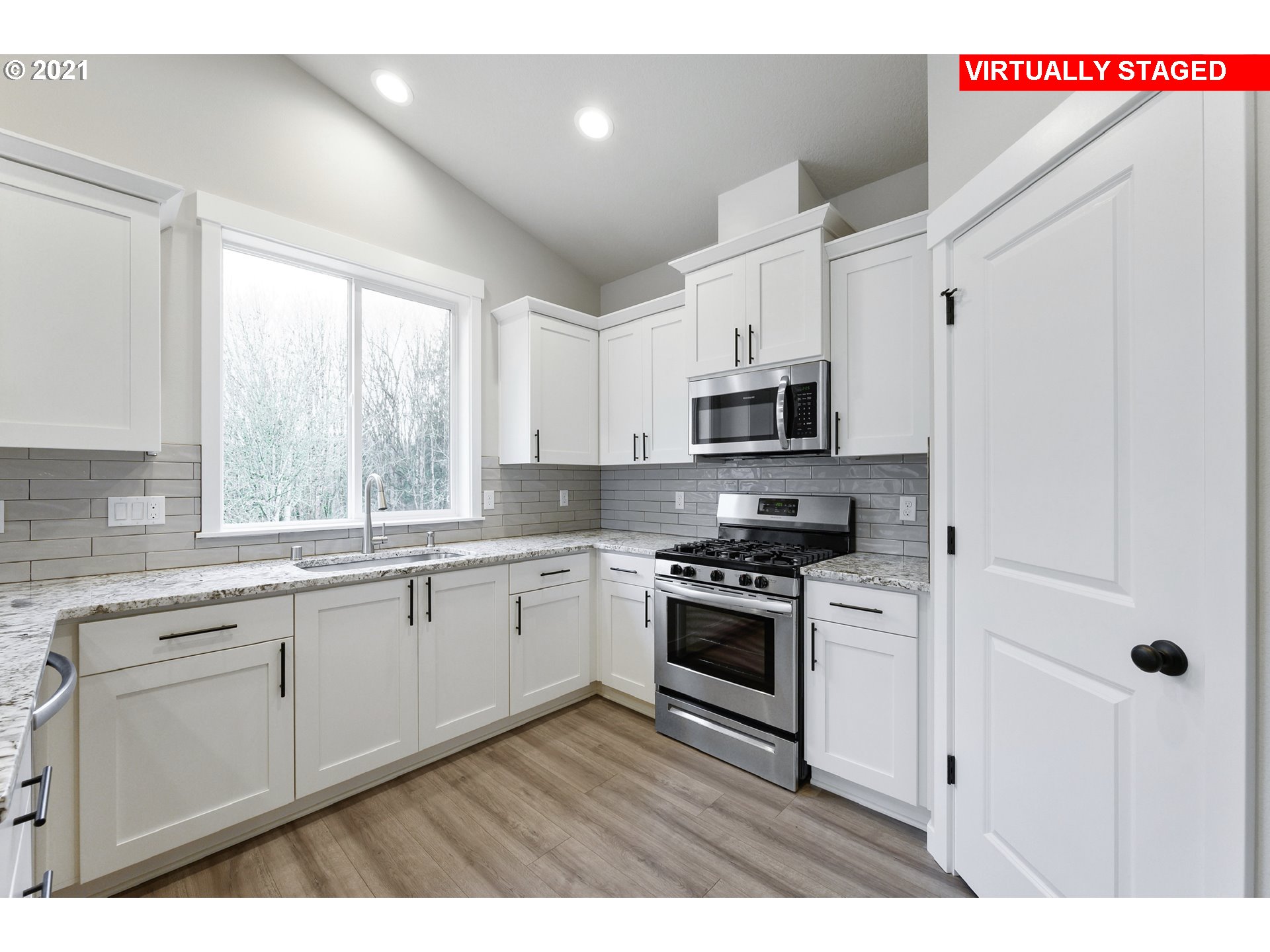 8719 North 5th Street, Unit LT50 Ridgefield, WA 98642 - Photo 3 of 31 a kitchen with stainless steel appliances a sink cabinets and a window
