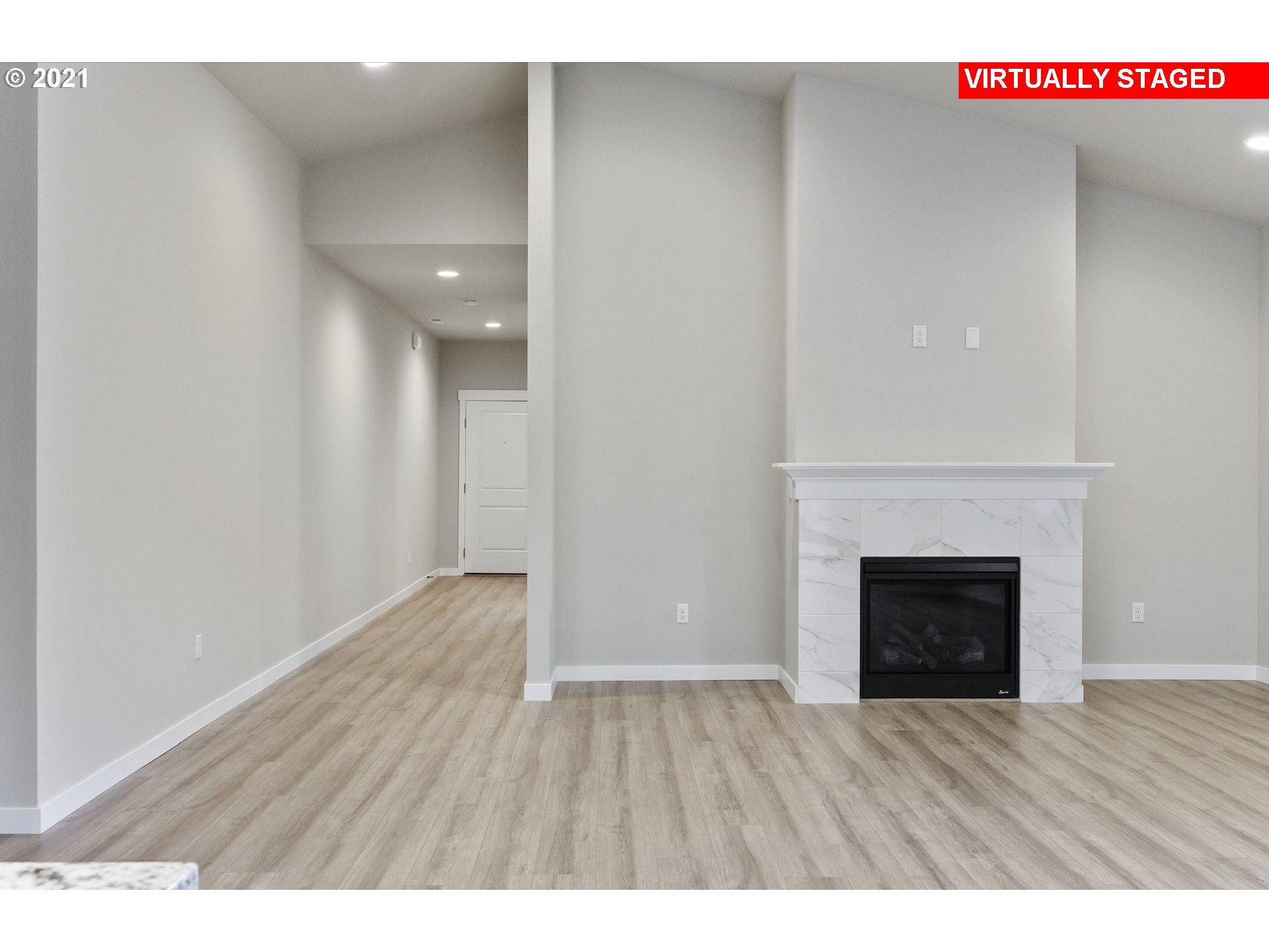 8719 North 5th Street, Unit LT50 Ridgefield, WA 98642 - Photo 9 of 31 a view of an empty room with wooden floor and a fireplace