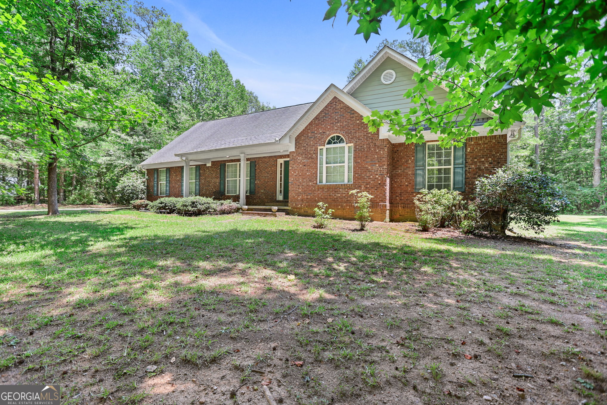 892 Brooks Woolsey Road Brooks, GA 30205 - Photo 4 of 45 a front view of a house with garden