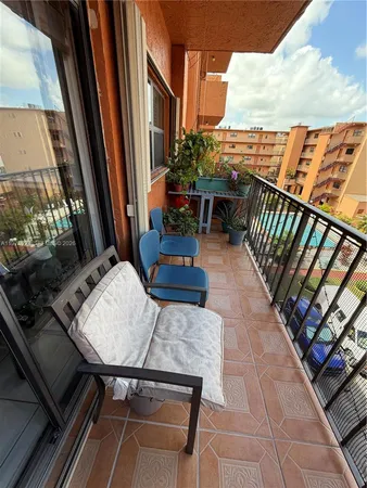 a balcony with wooden benches and city view