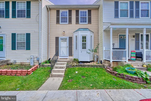 a view of a house with a yard and garden