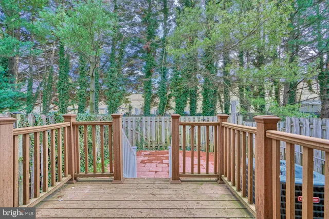 a view of balcony with wooden floor and fence