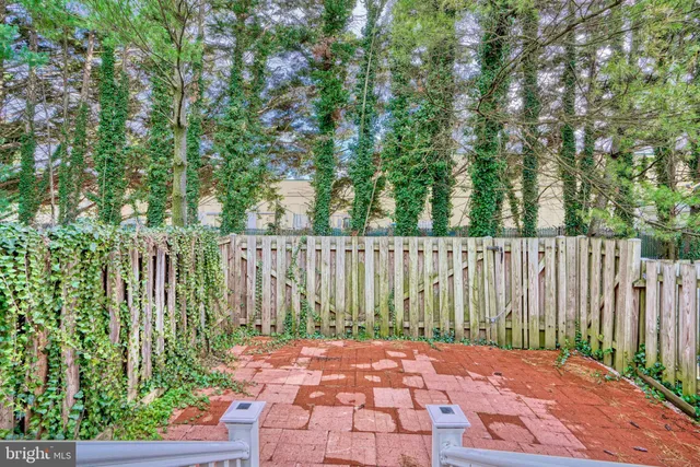 a view of small yard with plants and wooden fence