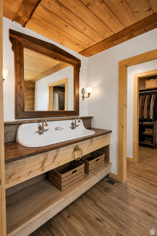 544 East 600 North, Unit 1 Joseph, UT 84739 - Photo 19 of 65 Bathroom featuring a rustic wood vanity with integrated double sink and dual wall-mounted faucets