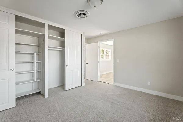 a view of an empty room with a closet