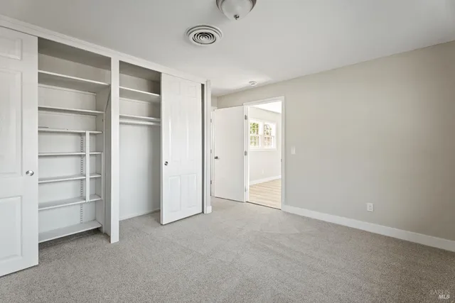 a view of an empty room with a closet