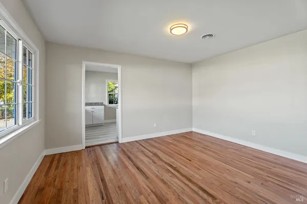 wooden floor in an empty room with a window