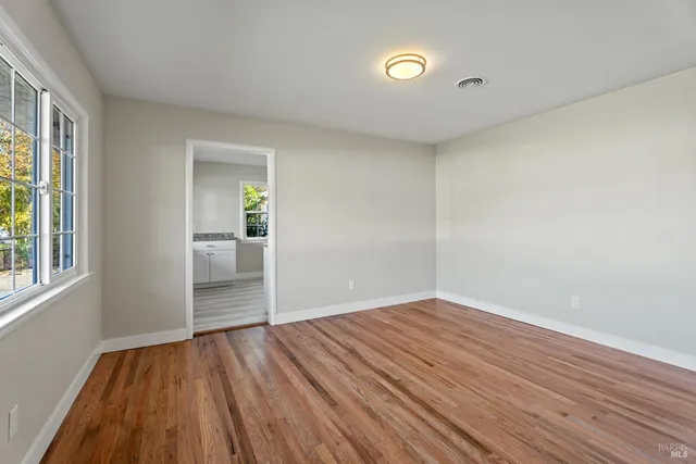 wooden floor in an empty room with a window