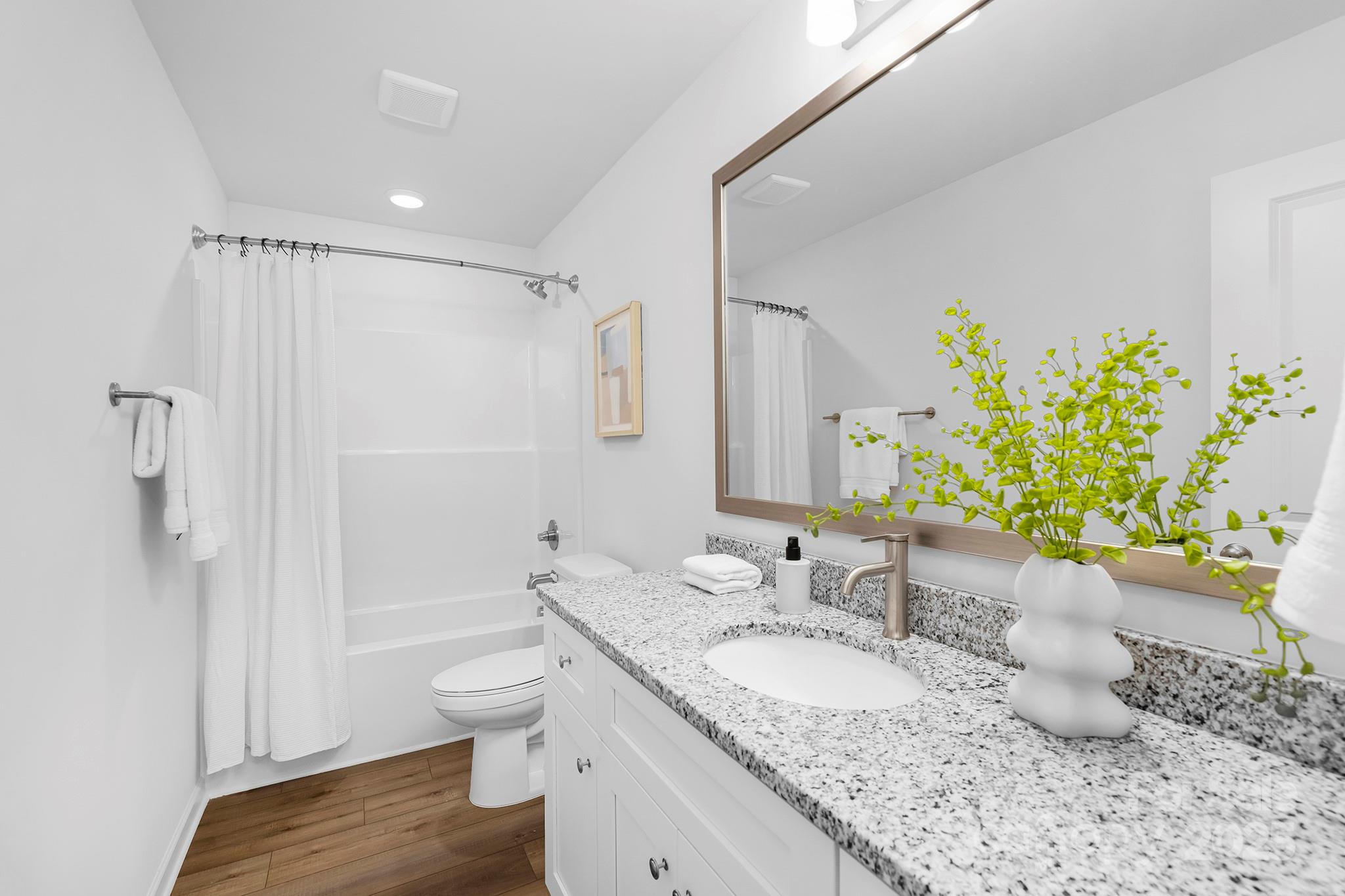 602 Westover Street Gastonia, NC 28054 - Photo 16 of 20 a bathroom with a granite countertop sink toilet and shower