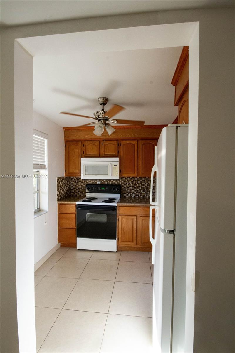 3000 Northwest 48th Terrace, Unit 322 Lauderdale Lakes, FL 33313 - Photo 3 of 15 a kitchen with stainless steel appliances a refrigerator and a stove