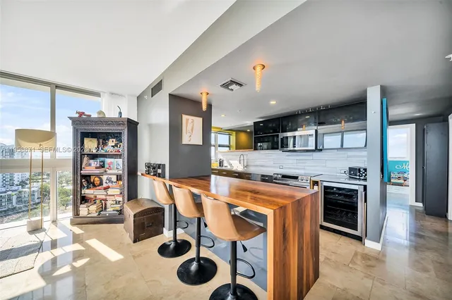 a kitchen with stainless steel appliances granite countertop a stove and a refrigerator
