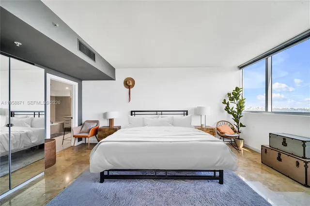 a bedroom with bed and window