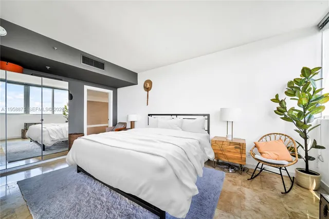 a bedroom with a bed chair and window