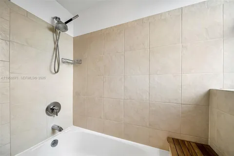 a bathroom with a shower and a bathtub