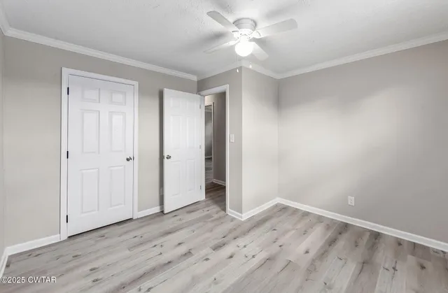 a view of empty room with wooden floor