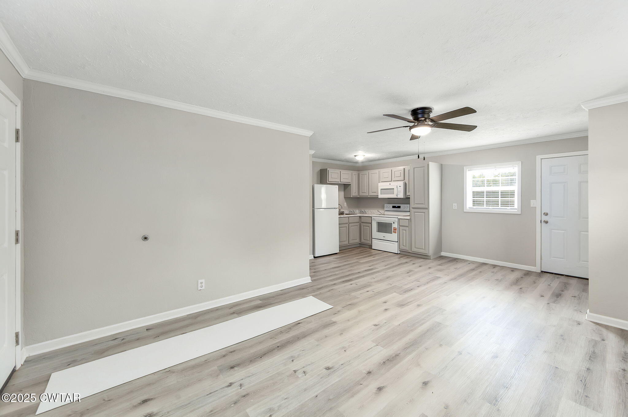 2025 Overton Loop Toone, TN 38381 - Photo 5 of 14 a view of empty room with wooden floor and window
