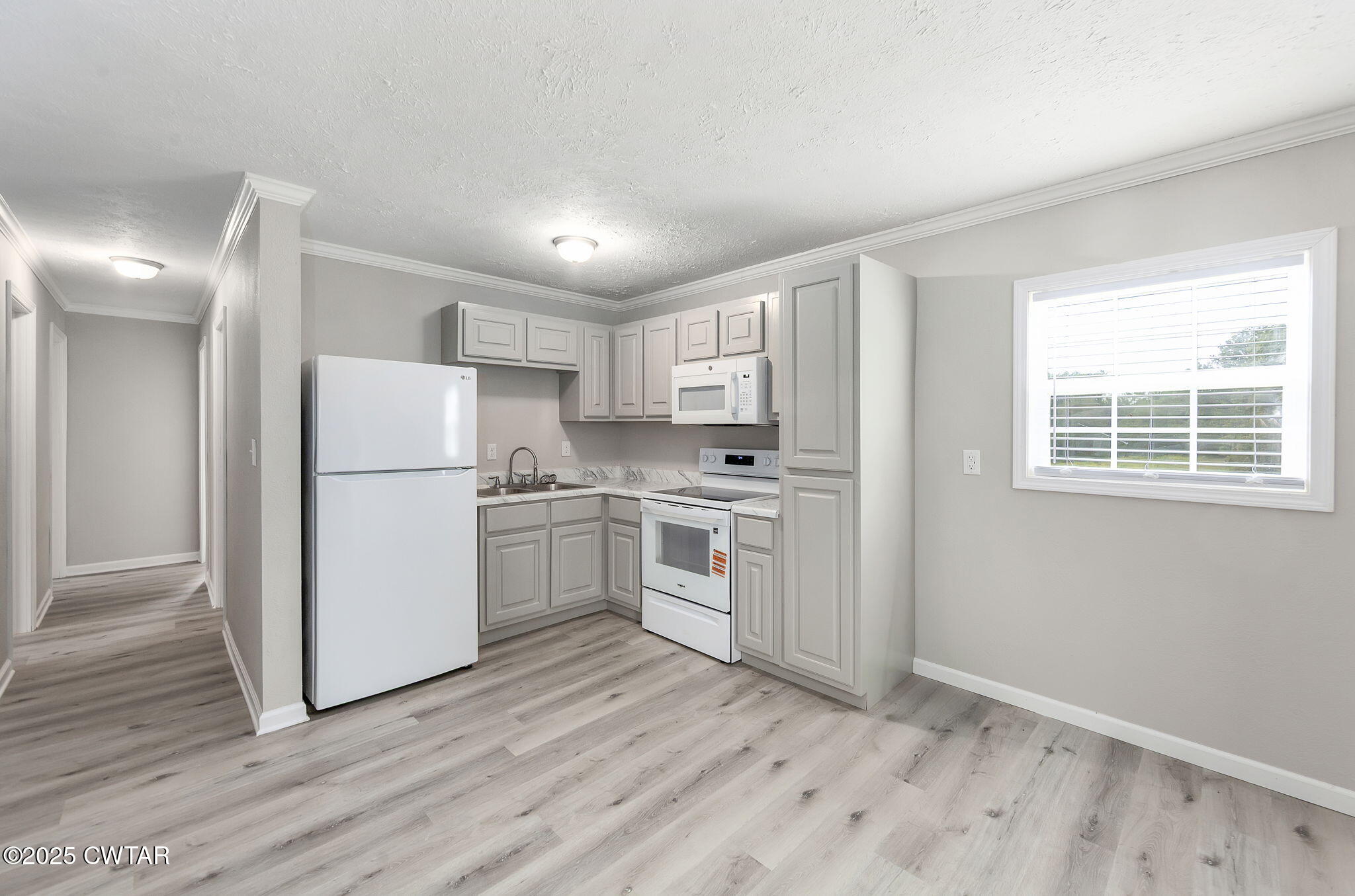 2025 Overton Loop Toone, TN 38381 - Photo 6 of 14 a kitchen with white cabinets and white appliances