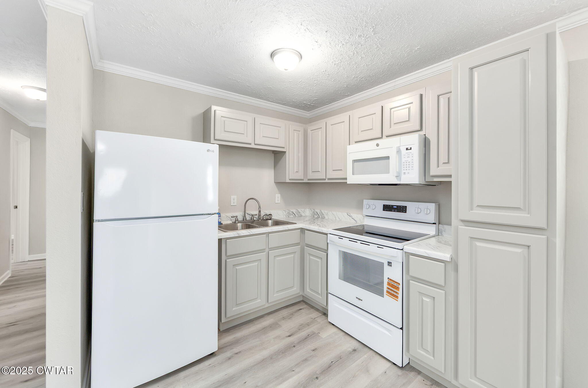 2025 Overton Loop Toone, TN 38381 - Photo 7 of 14 a kitchen with a refrigerator sink stove and cabinets