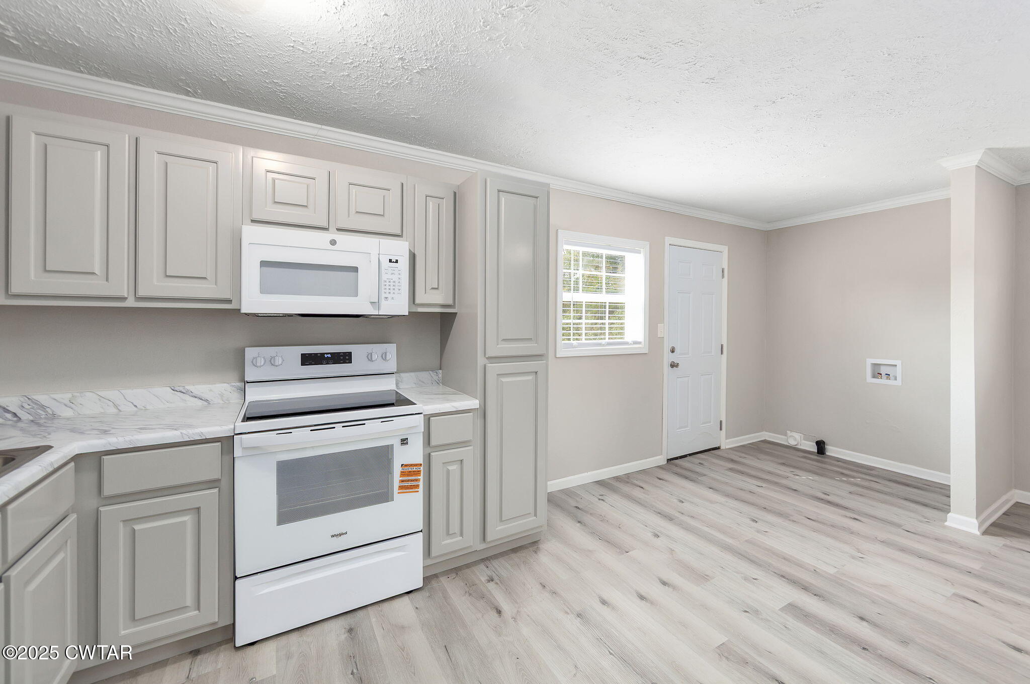2025 Overton Loop Toone, TN 38381 - Photo 8 of 14 a kitchen with white cabinets and white appliances