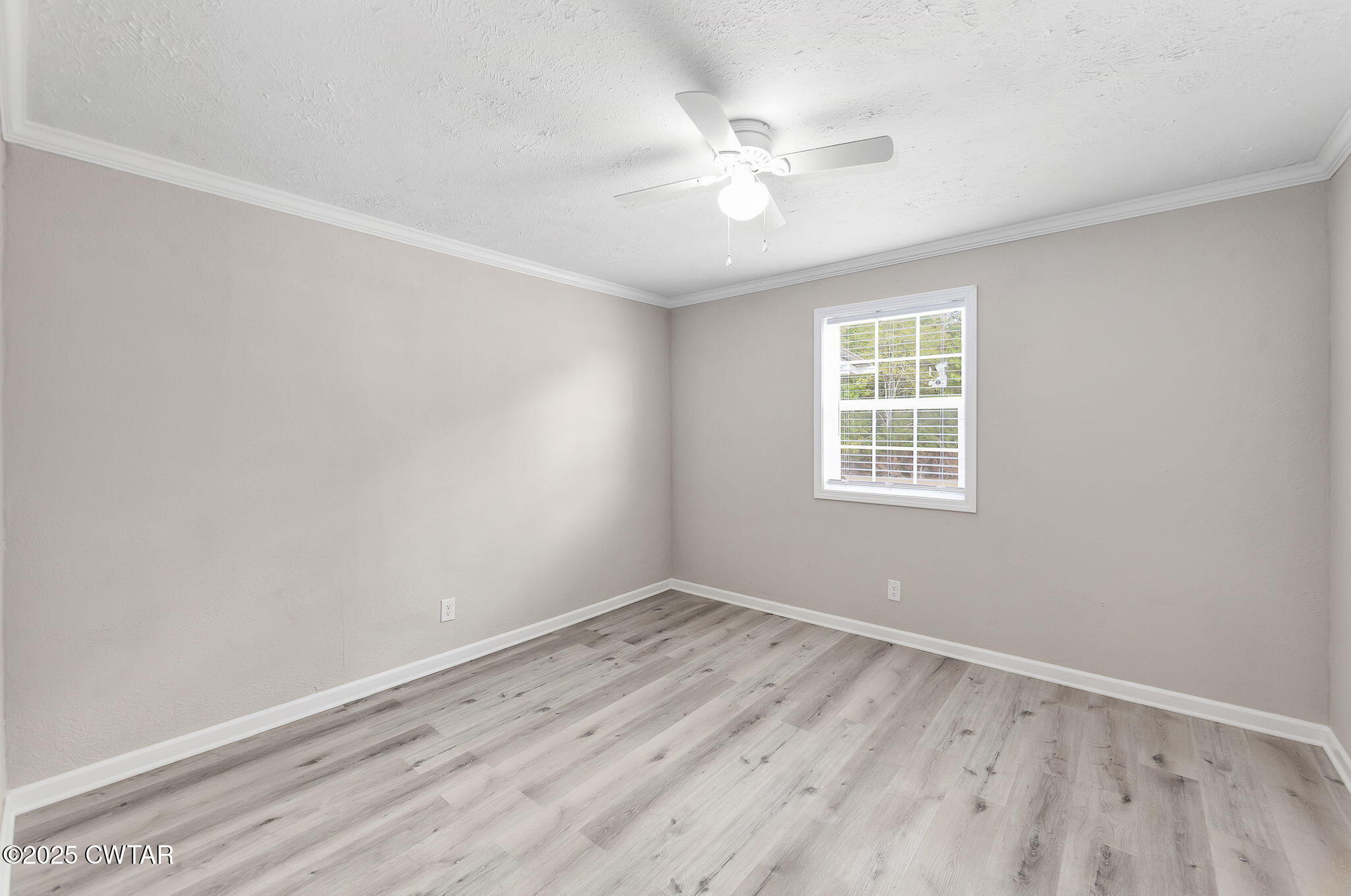 2025 Overton Loop Toone, TN 38381 - Photo 10 of 14 wooden floor in an empty room with a window