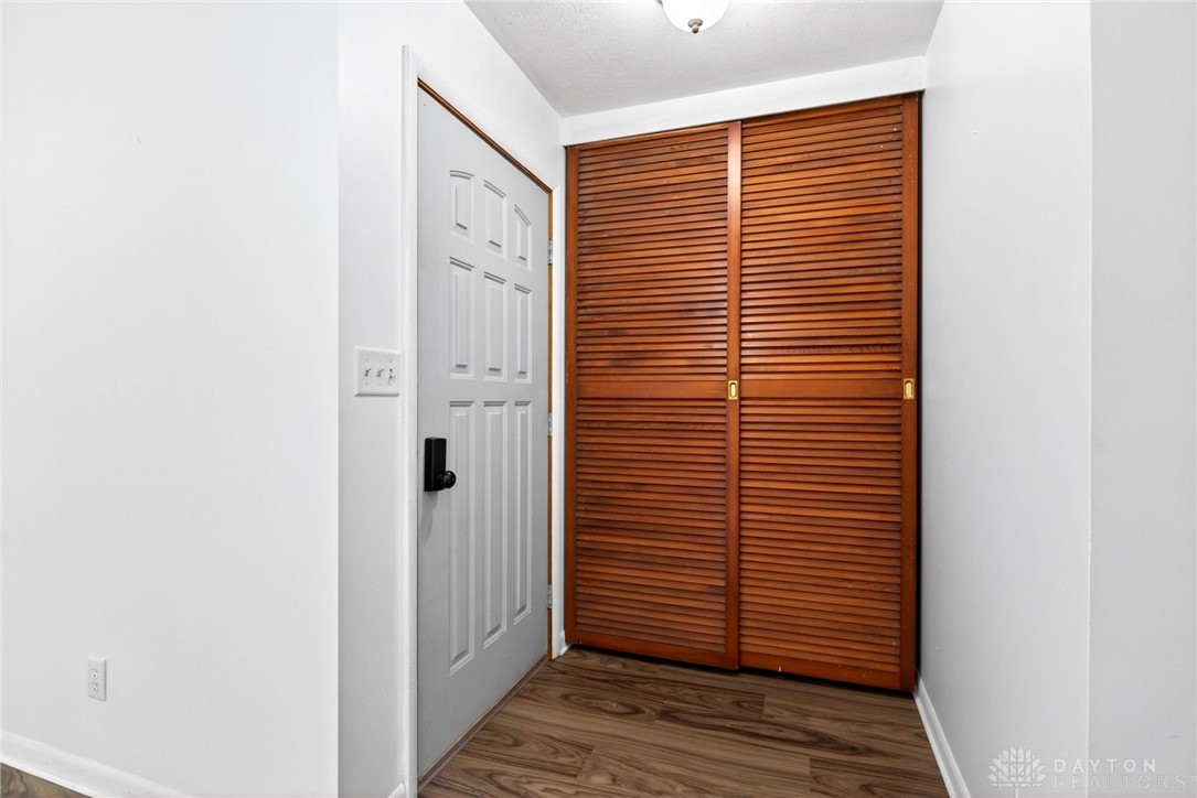 1005 Free Road New Carlisle, OH 45344 - Photo 5 of 43 This entry features warm wood flooring and a convenient louvered closet.