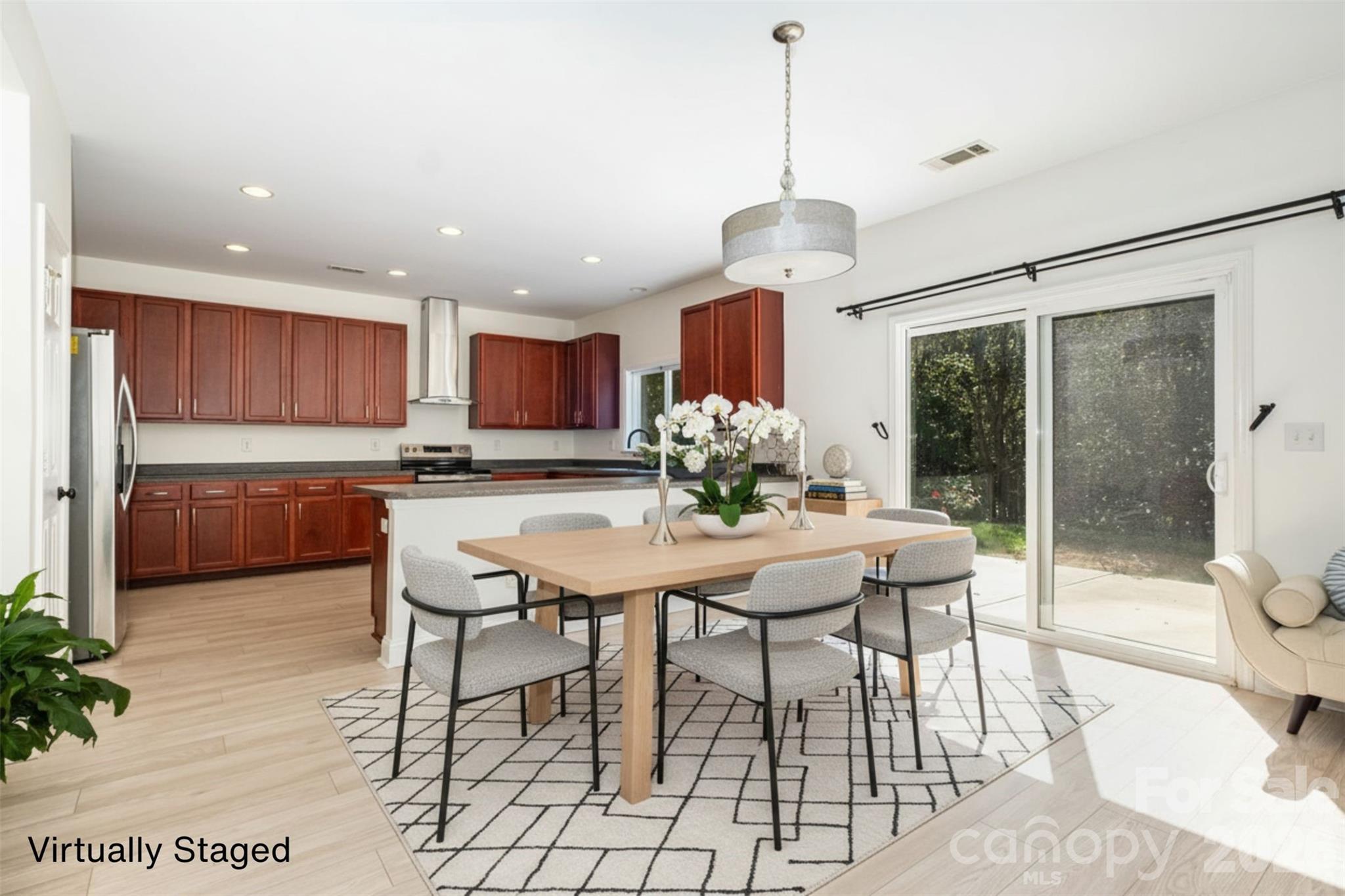9213 Seamill Road Charlotte, NC 28278 - Photo 12 of 33 a view of a dining room and livingroom with furniture wooden floor a chandelier