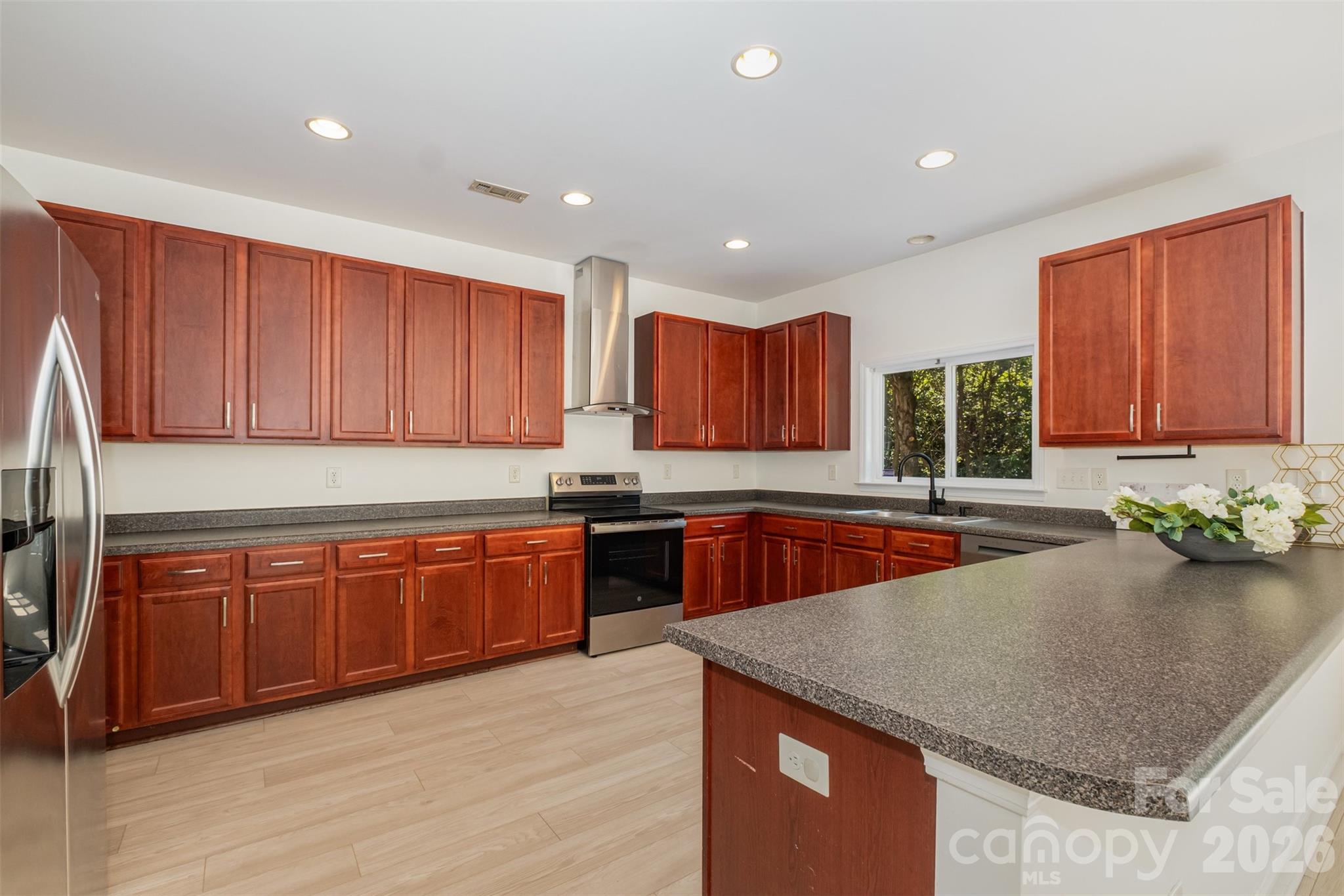 9213 Seamill Road Charlotte, NC 28278 - Photo 13 of 33 a kitchen with stainless steel appliances granite countertop wooden cabinets a oven and granite counter tops with a large window