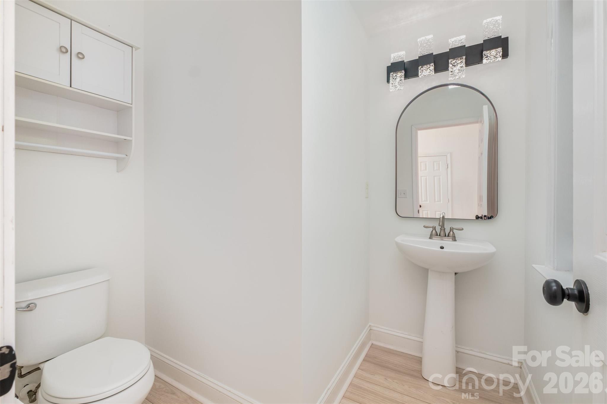 9213 Seamill Road Charlotte, NC 28278 - Photo 15 of 33 a bathroom with a sink mirror and toilet