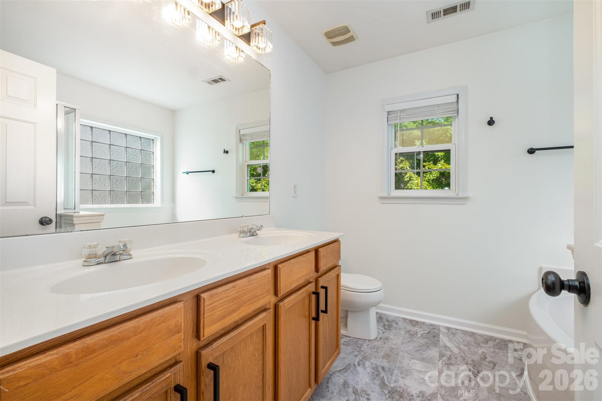 9213 Seamill Road Charlotte, NC 28278 - Photo 22 of 33 a bathroom with a sink toilet and shower