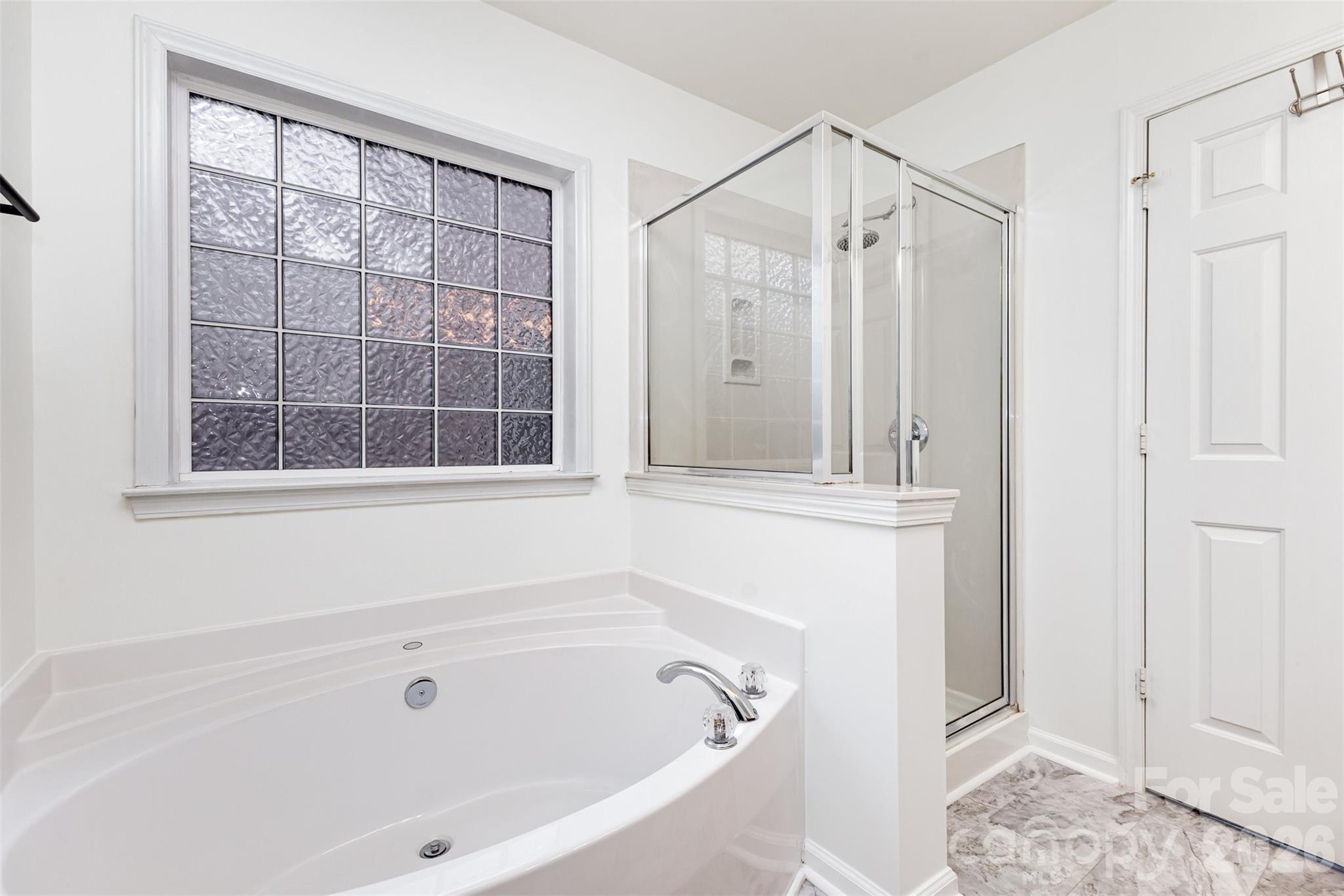 9213 Seamill Road Charlotte, NC 28278 - Photo 23 of 33 a bathroom with a bathtub and a shower