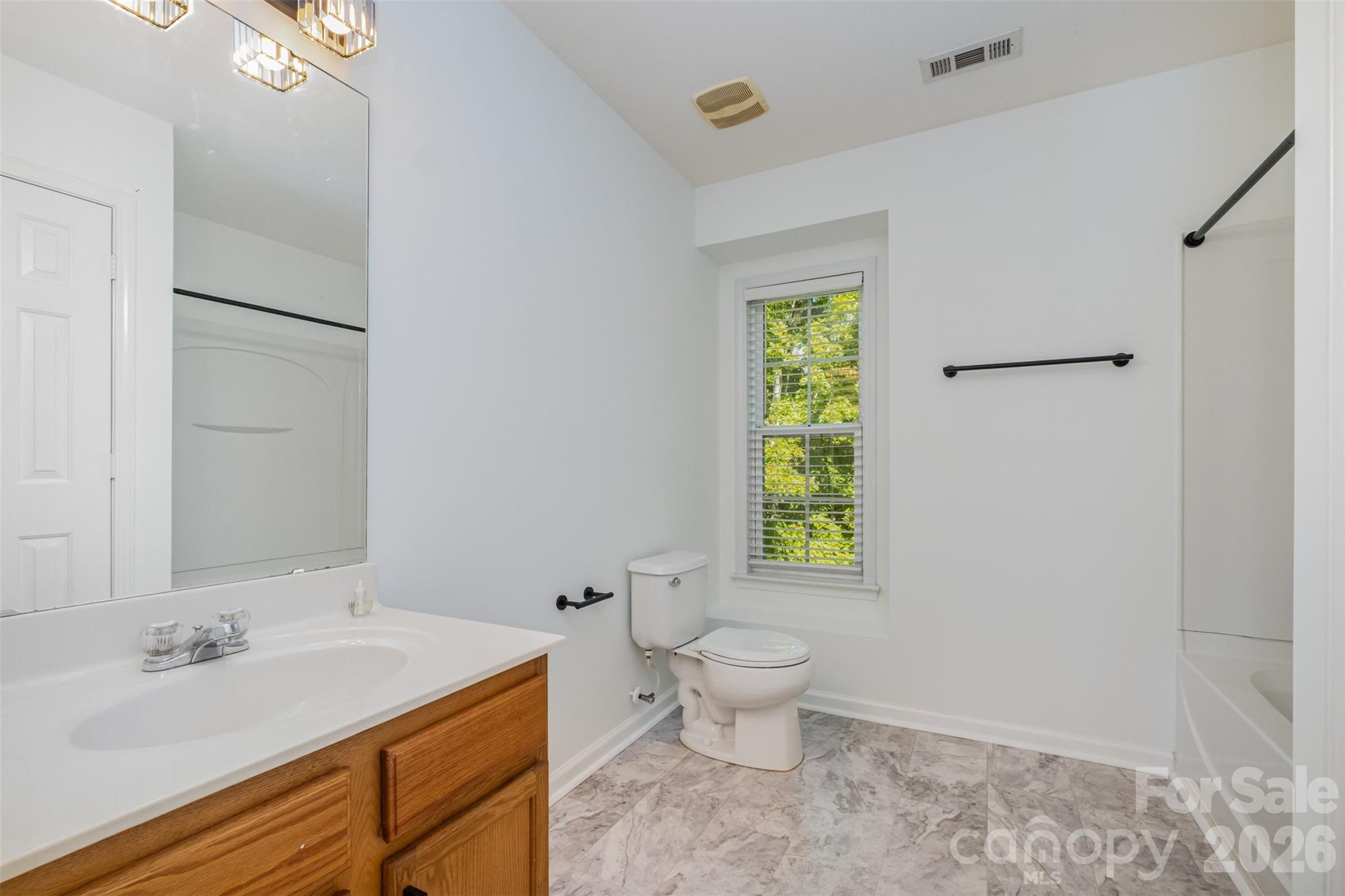 9213 Seamill Road Charlotte, NC 28278 - Photo 27 of 33 a bathroom with a sink toilet and a mirror