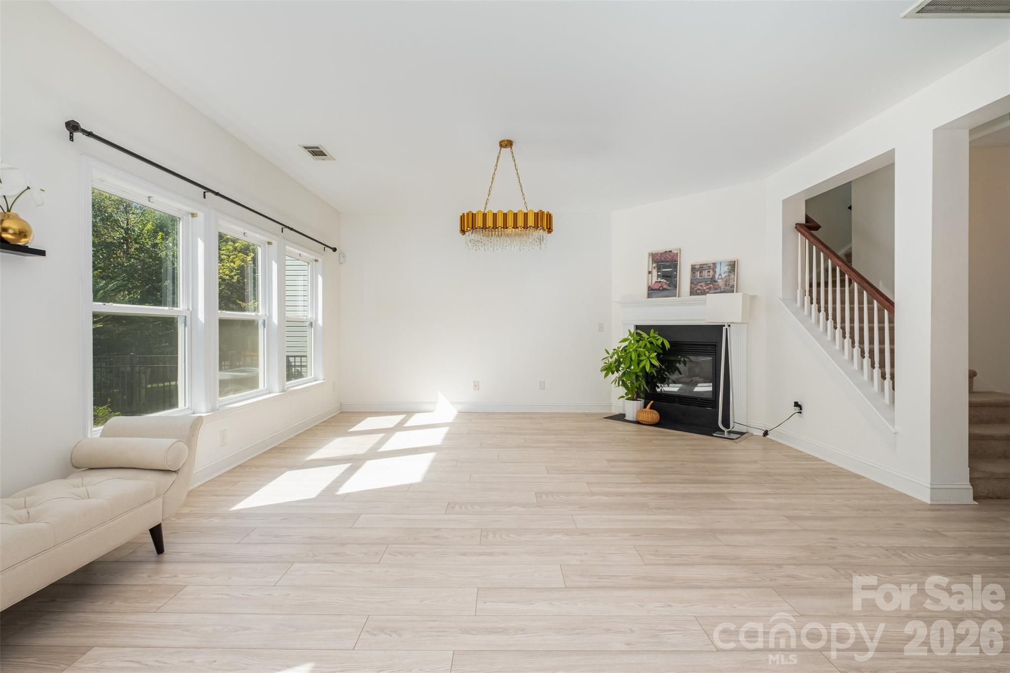 9213 Seamill Road Charlotte, NC 28278 - Photo 7 of 33 a view of an empty room with a window and hardwood floor