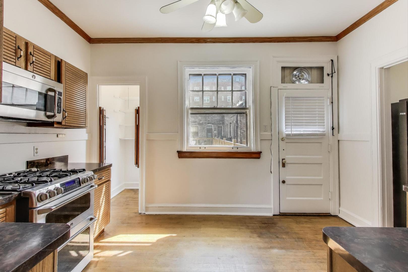 1641 Hinman Avenue, Unit 3 Evanston, IL 60201 - Photo 18 of 30 a kitchen with stainless steel appliances a stove and a refrigerator