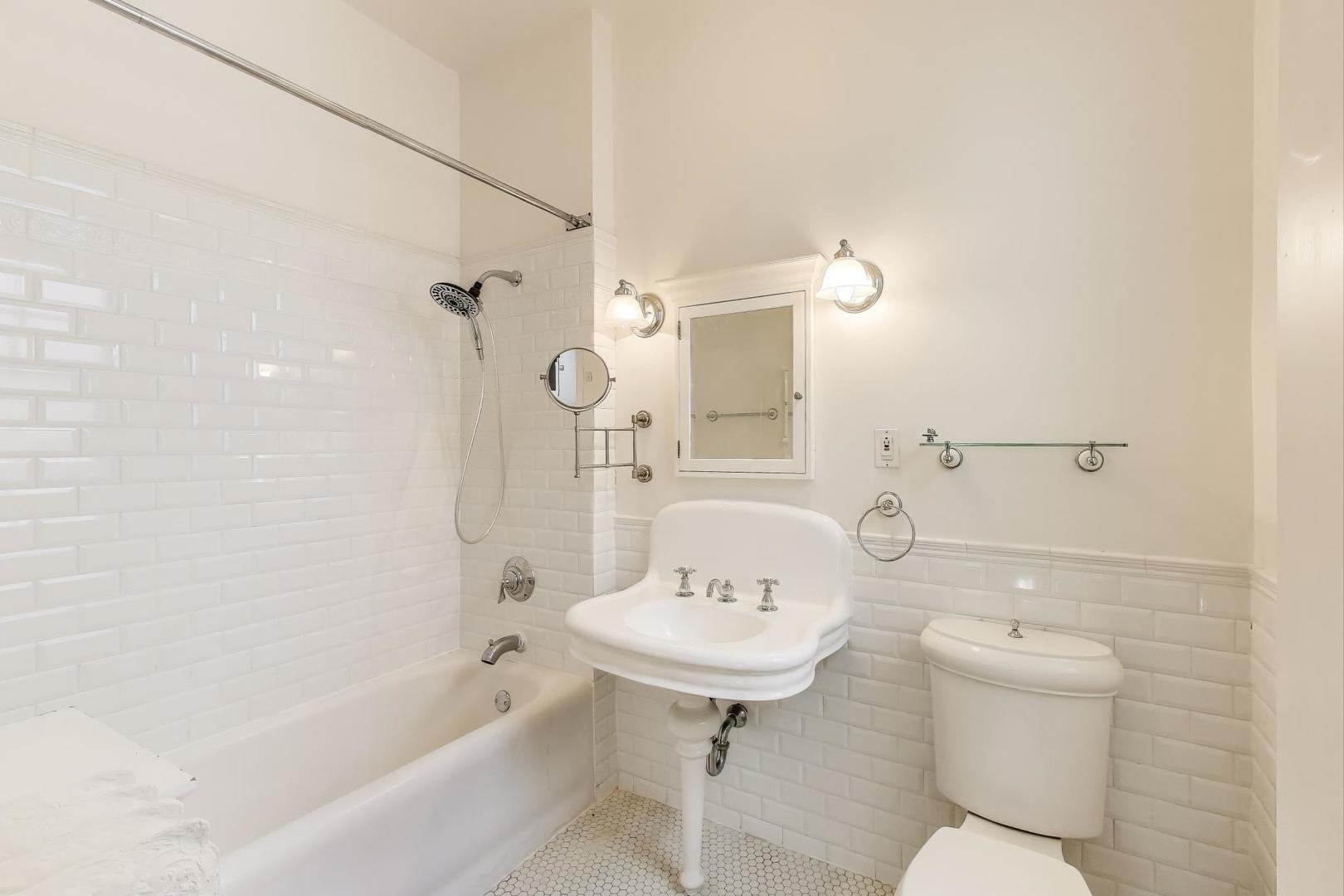 1641 Hinman Avenue, Unit 3 Evanston, IL 60201 - Photo 26 of 30 a bathroom with a sink a toilet and shower