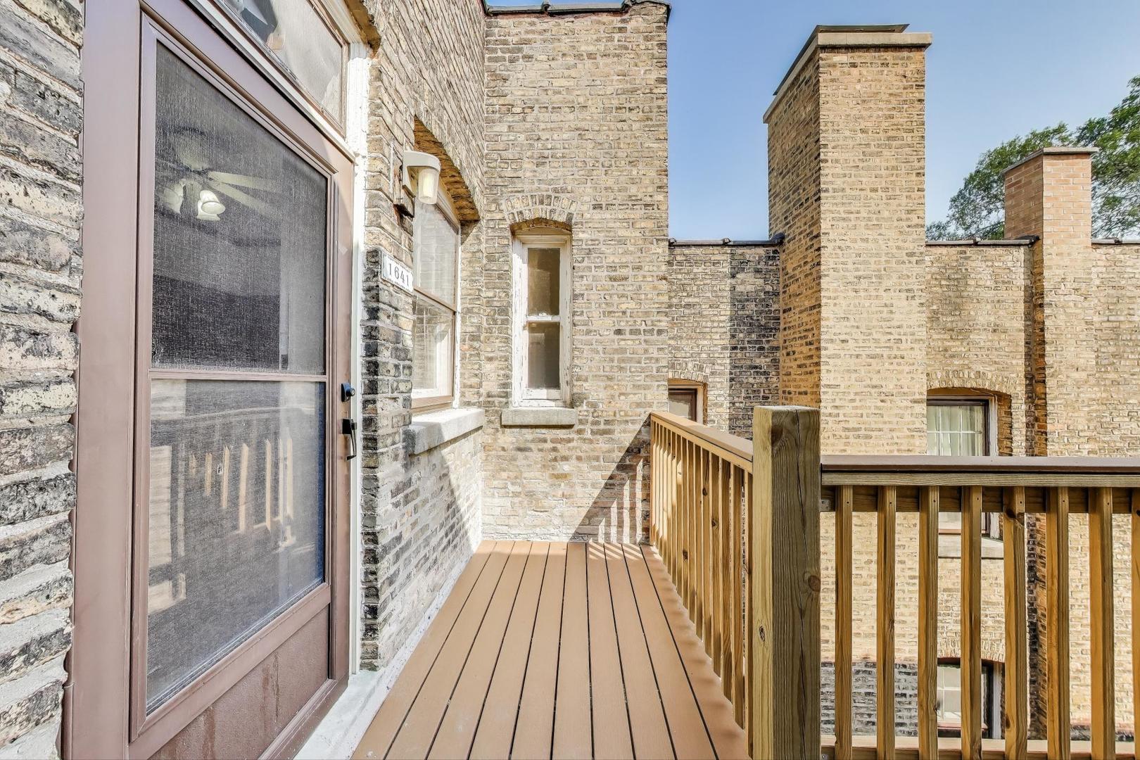 1641 Hinman Avenue, Unit 3 Evanston, IL 60201 - Photo 29 of 30 a view of a balcony with wooden floor and iron stairs