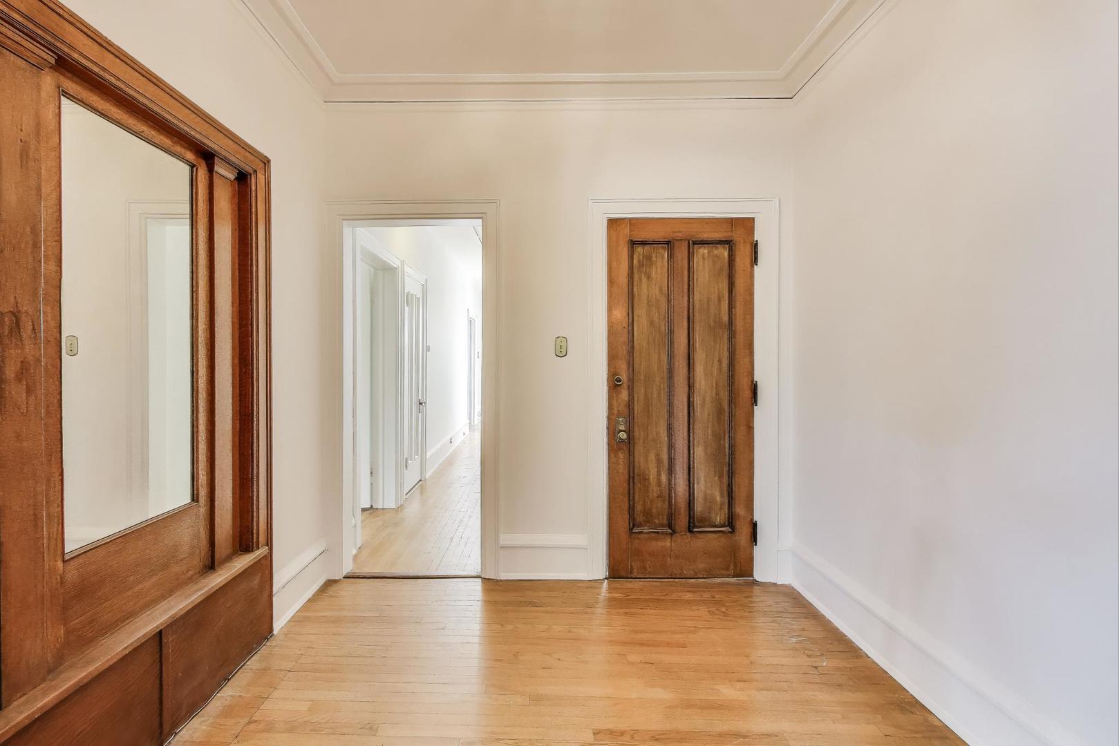 1641 Hinman Avenue, Unit 3 Evanston, IL 60201 - Photo 8 of 30 a view of a hallway with wooden floor