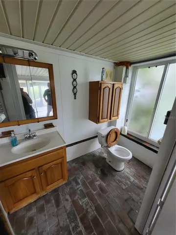 a view of a patio with a table and chairs under an umbrella