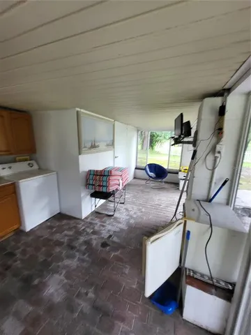 a view of a lake with a bench and trees around