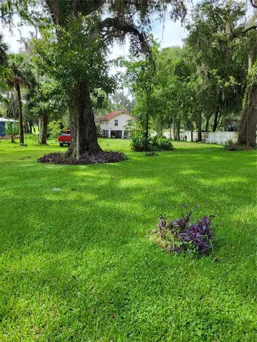 a view of a house with backyard porch and sitting area