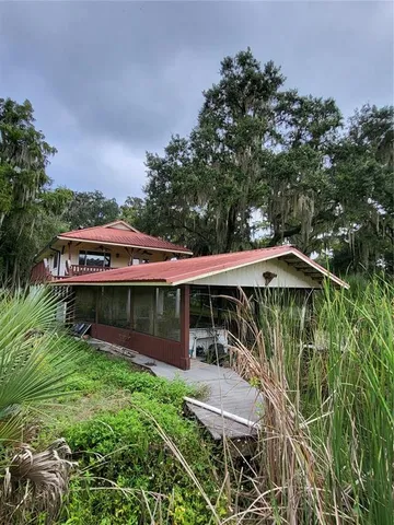 an outdoor view of house with swimming pool and green space