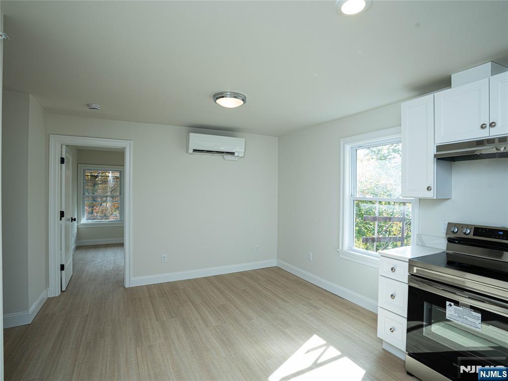 490 Broad Avenue, Unit 6 Leonia, NJ 07605 - Photo 2 of 8 wooden floor in an empty room with a window