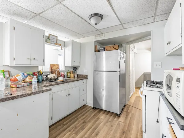 a kitchen with stainless steel appliances a refrigerator sink and cabinets