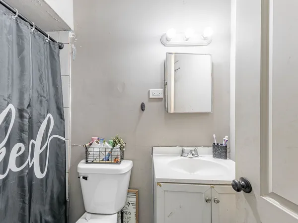 a bathroom with a sink a toilet and mirror